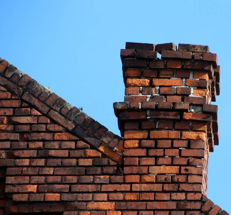 Damaged chimney on an Rowley home showing cracks and missing mortar